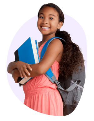 A girl looking up from her schoolwork